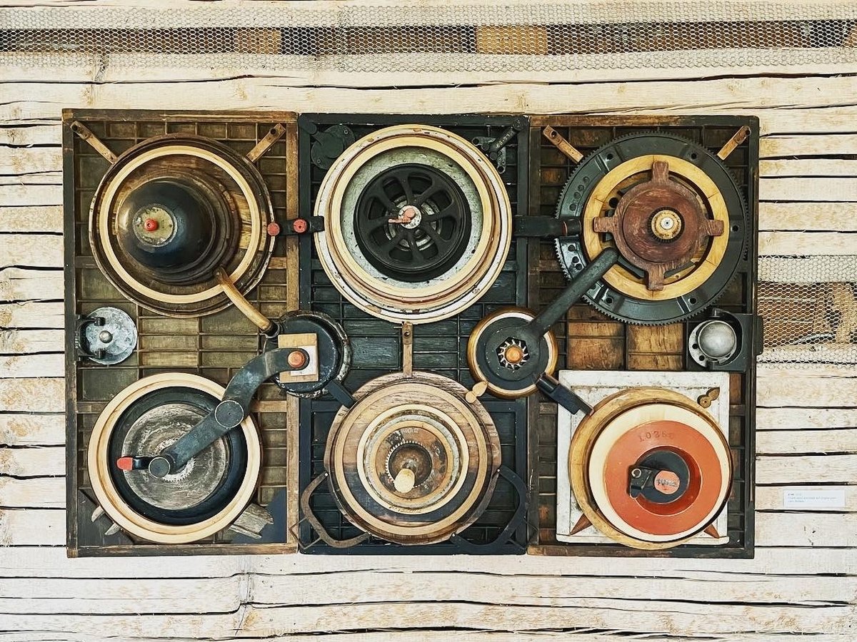 An assemblage artwork of six circular mechanical objects arranged in a grid, by Larry Simons, at Art at the Kent, Calais Vermont